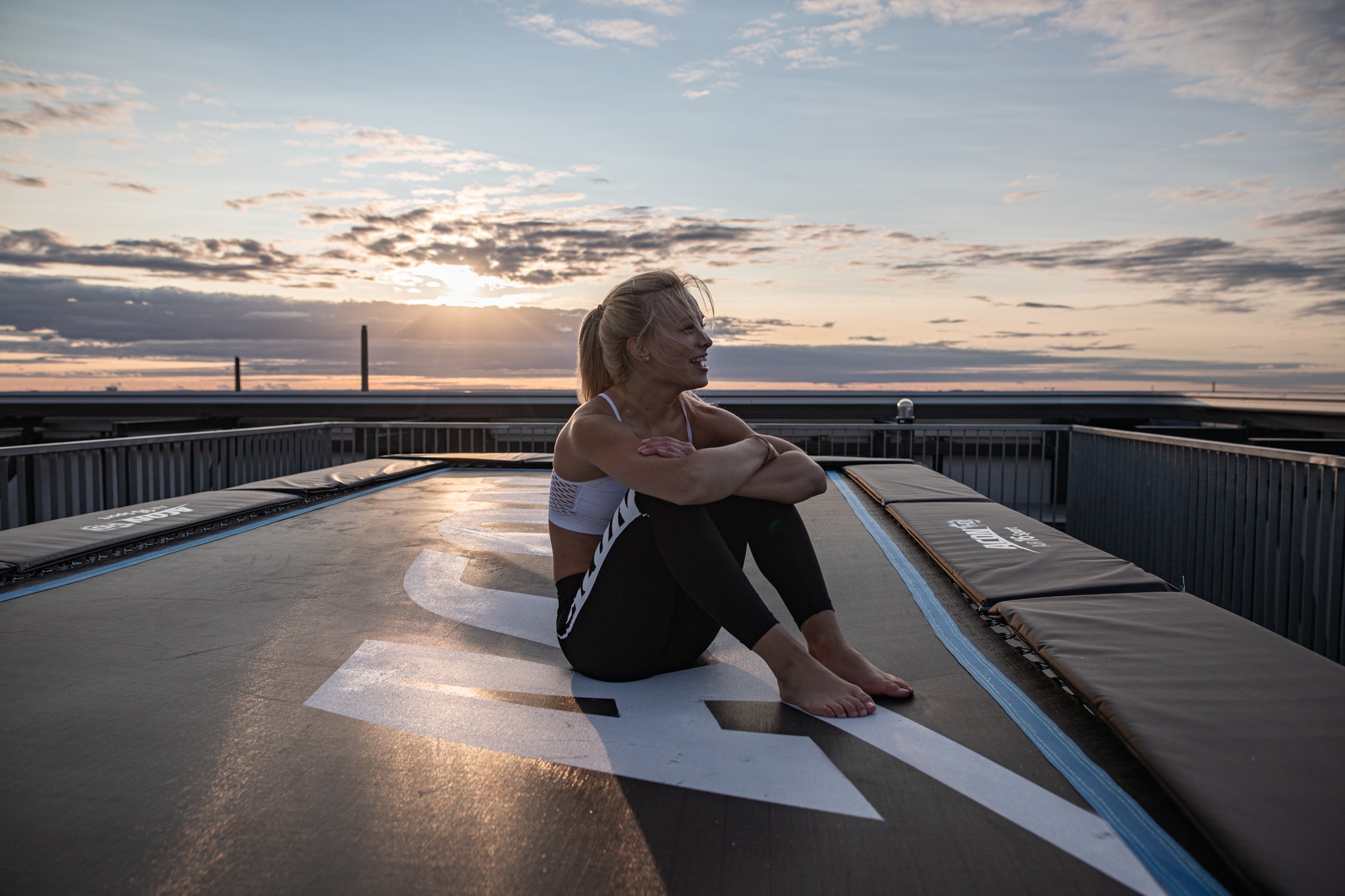 Woman sitting on an Acon trampoline