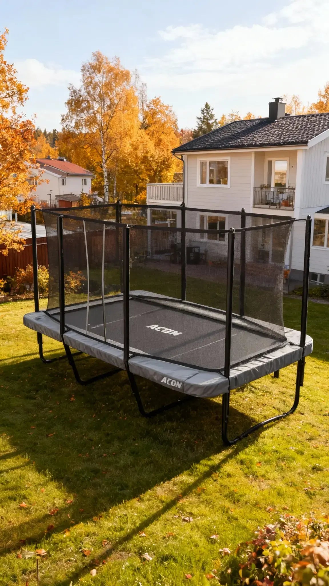 Acon HD 16 trampoline outdoors in a backyard in nice and cozy autumn weather. 