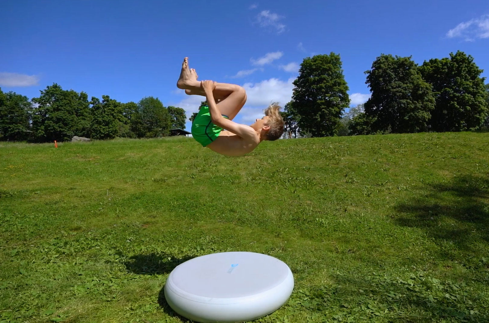 Acon airspot and a boy doing a backflip above it