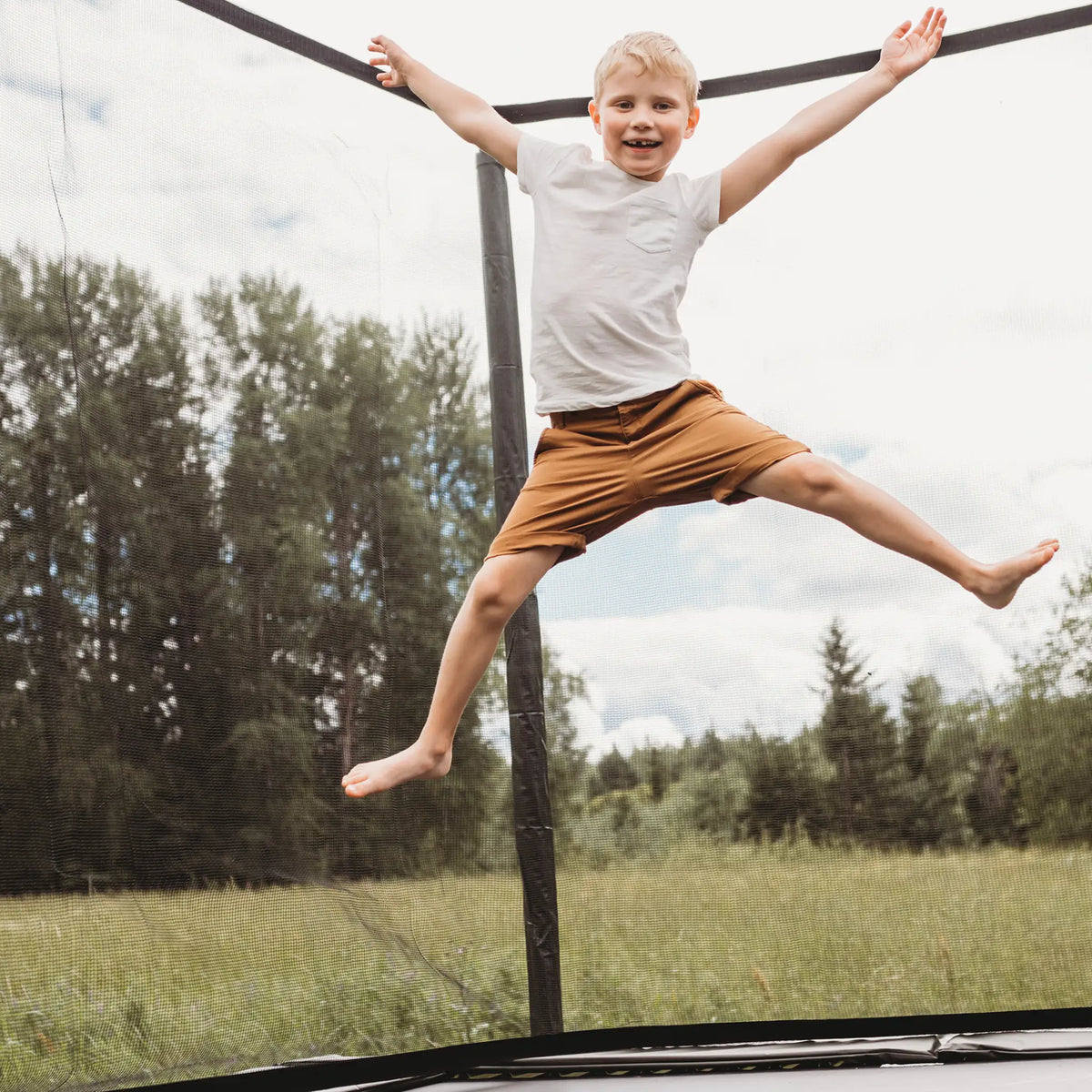 Young boy jumping high on a Acon trampoline.