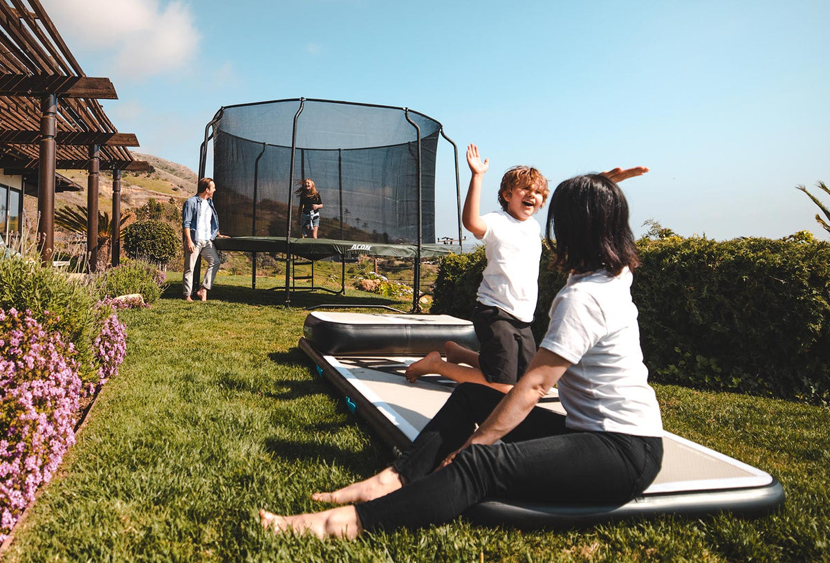 Family with ACON trampoline and airtracks