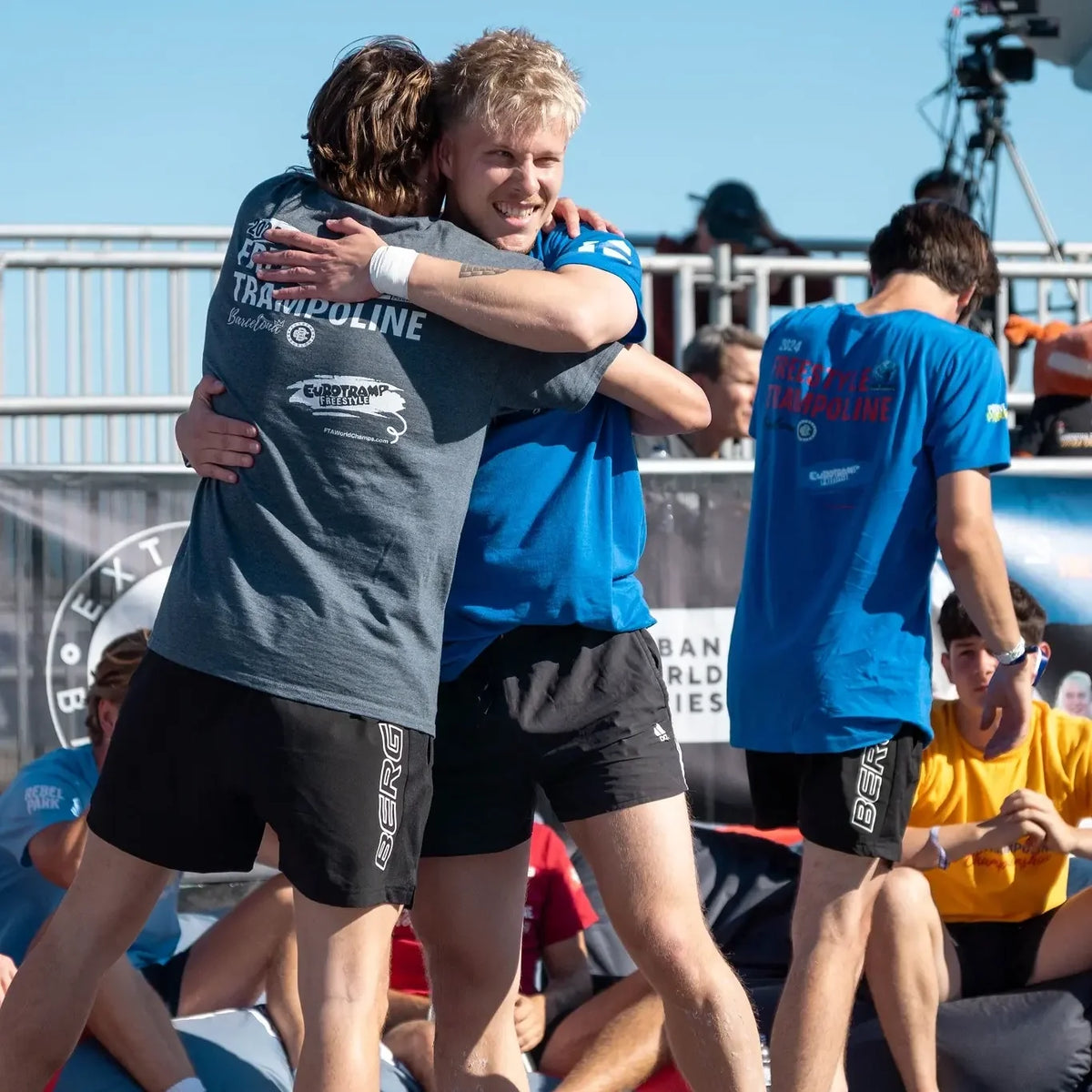 Freestyle trampoline athletes hugging at the 2024 World Championships in Barcelona.
