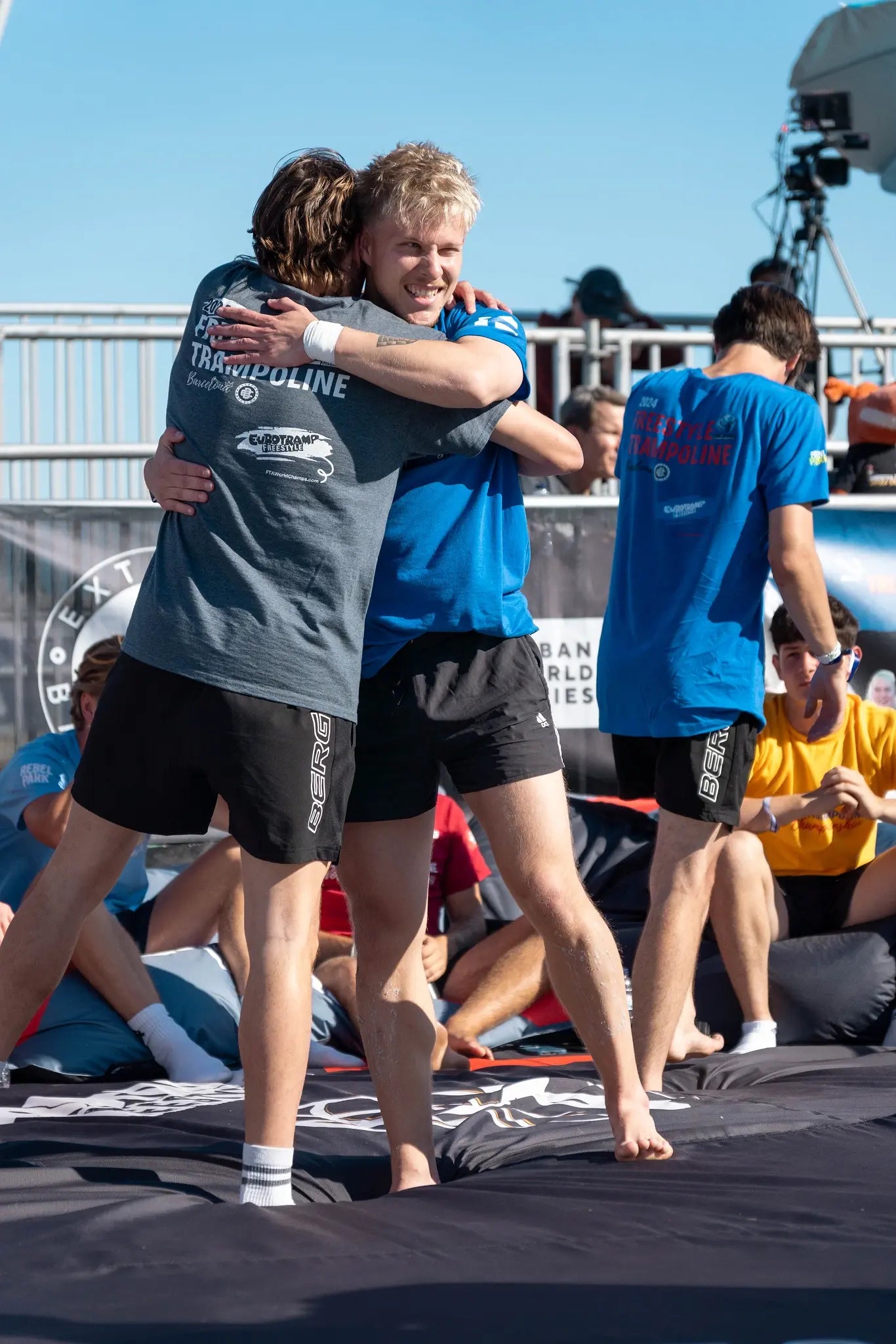 Freestyle trampoline athletes hugging at the 2024 World Championships in Barcelona.