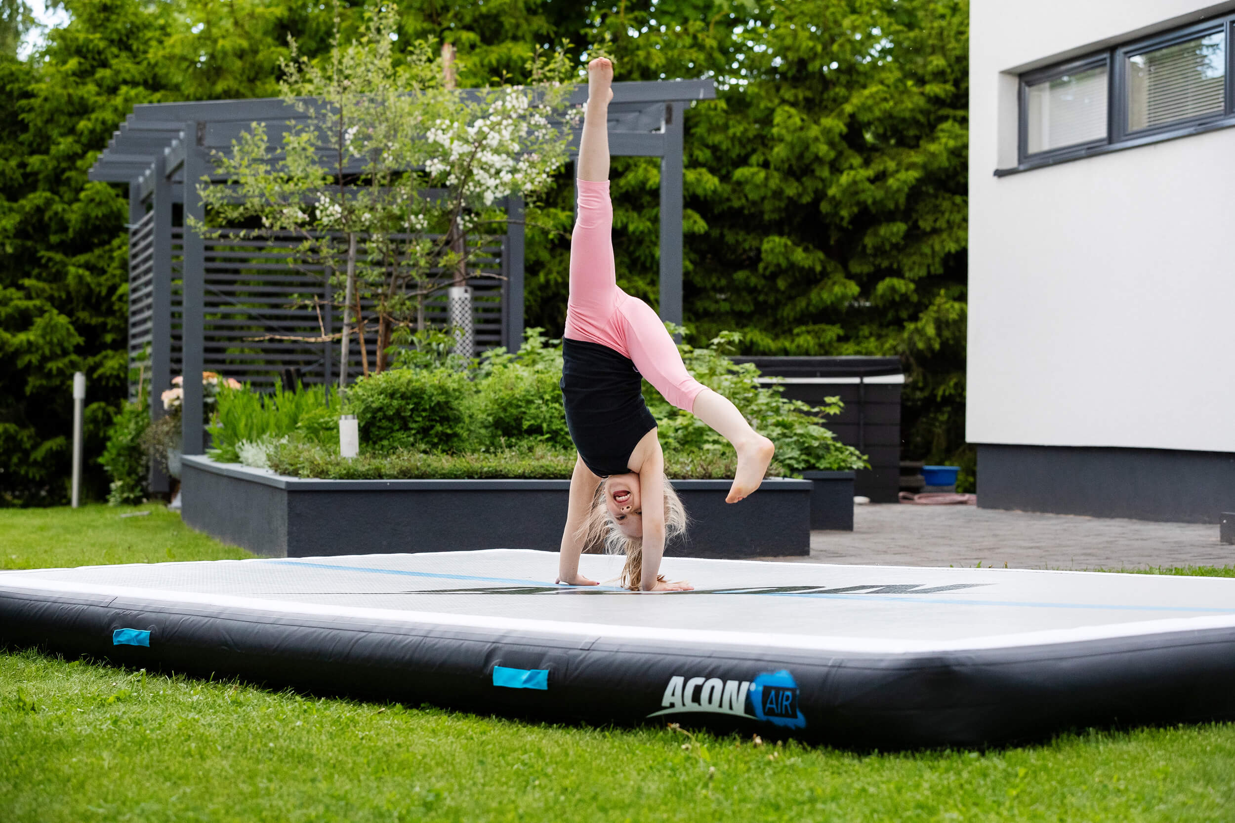 Girl doing cartwheel on Acon airtrack.