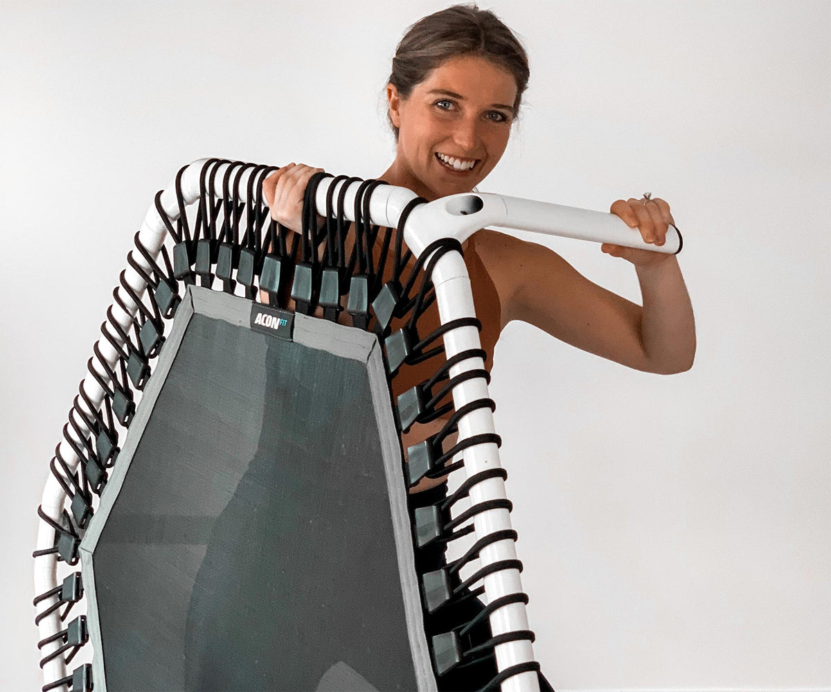 Sydney Ross holding the ACON fitness trampoline