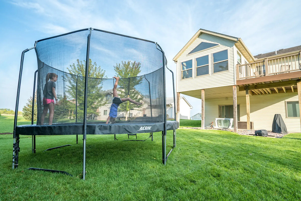 Two girls on a round Acon trampoline. 