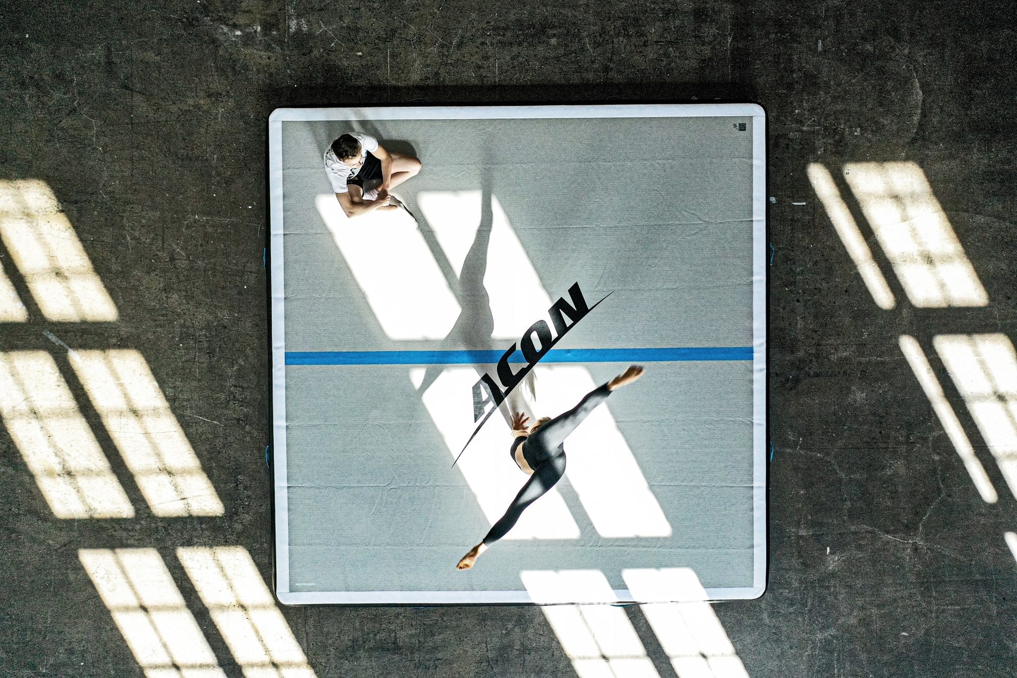 Gymnast woman volting on an Acon big airtrack.