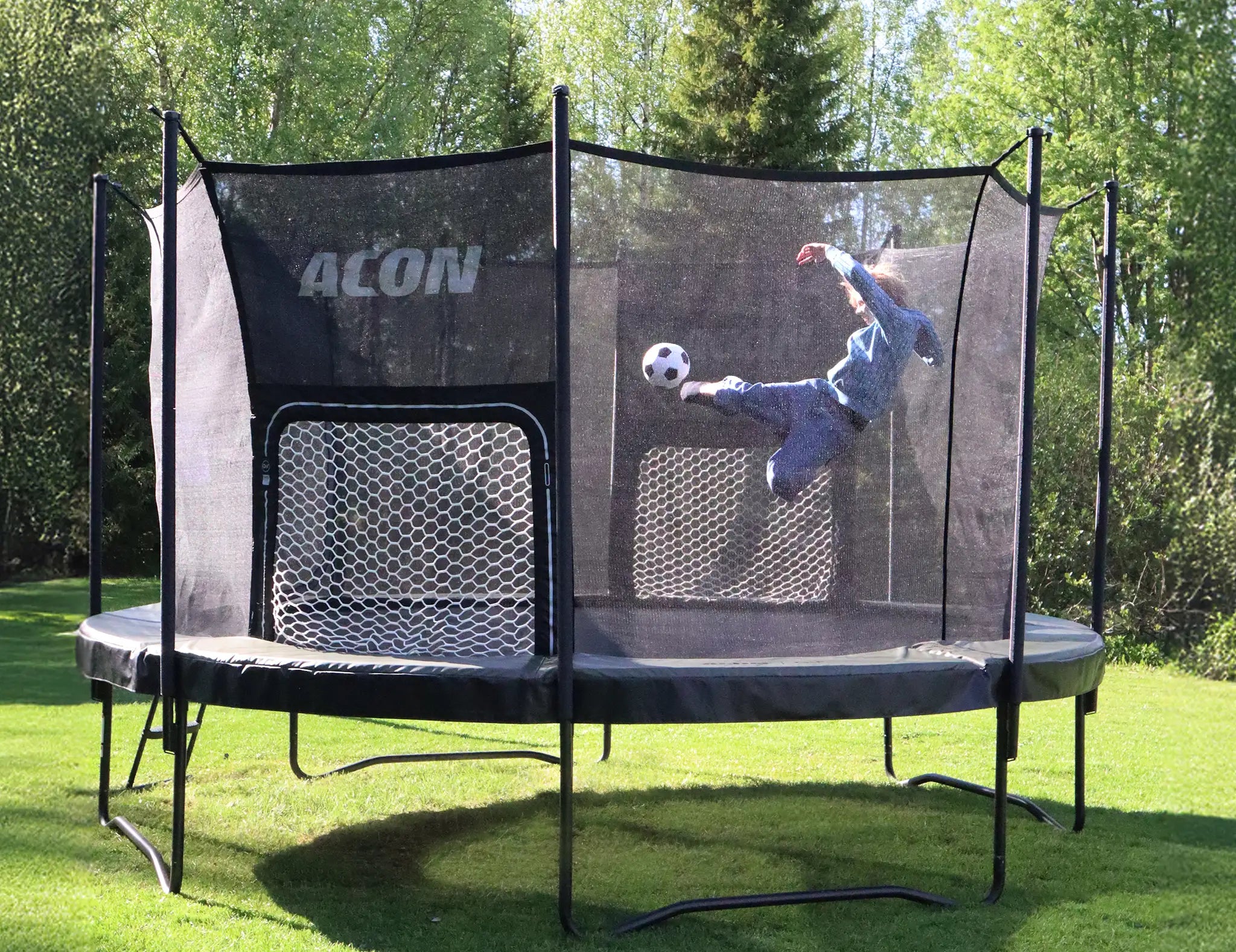 Person performing football kick on Acon trampoline with goal net for backyard sports play.