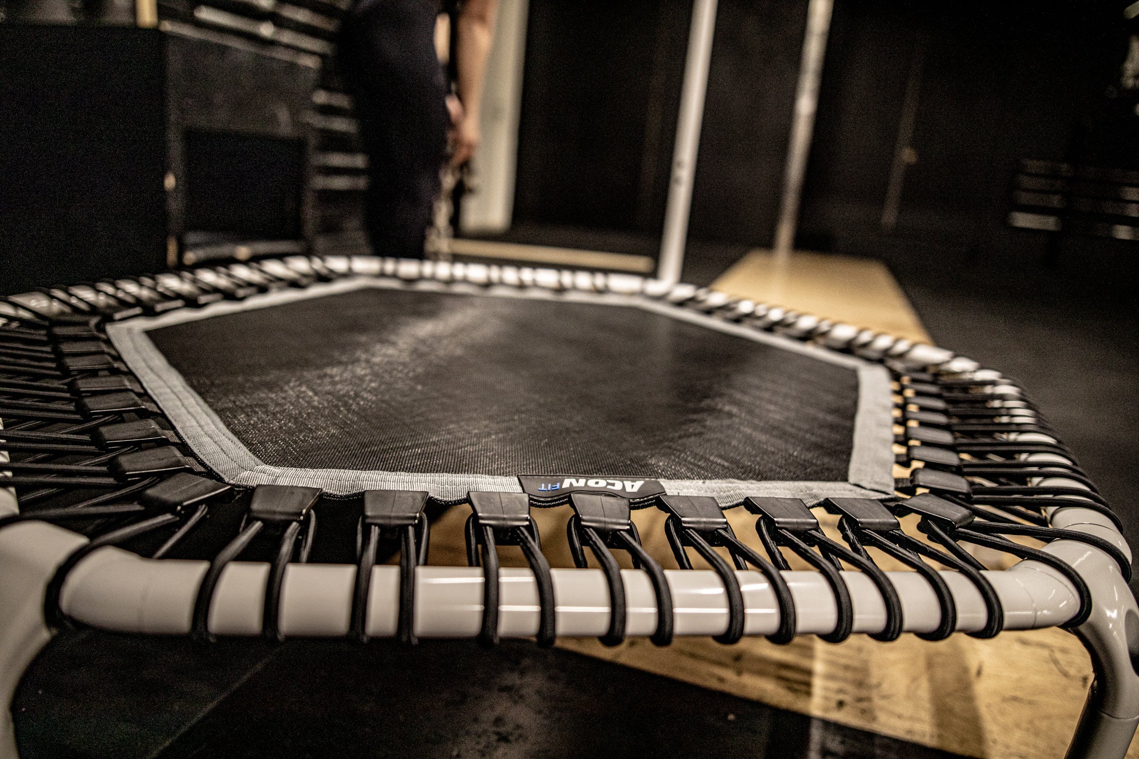 A closeup of the ACON hexagonal rebounder trampoline in white