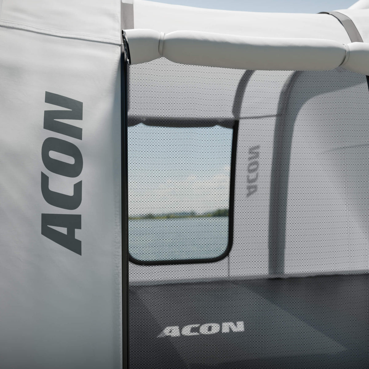 Close-up view of the door of the Acon Trampoline Tent, featuring the Acon logo on a white fabric panel.