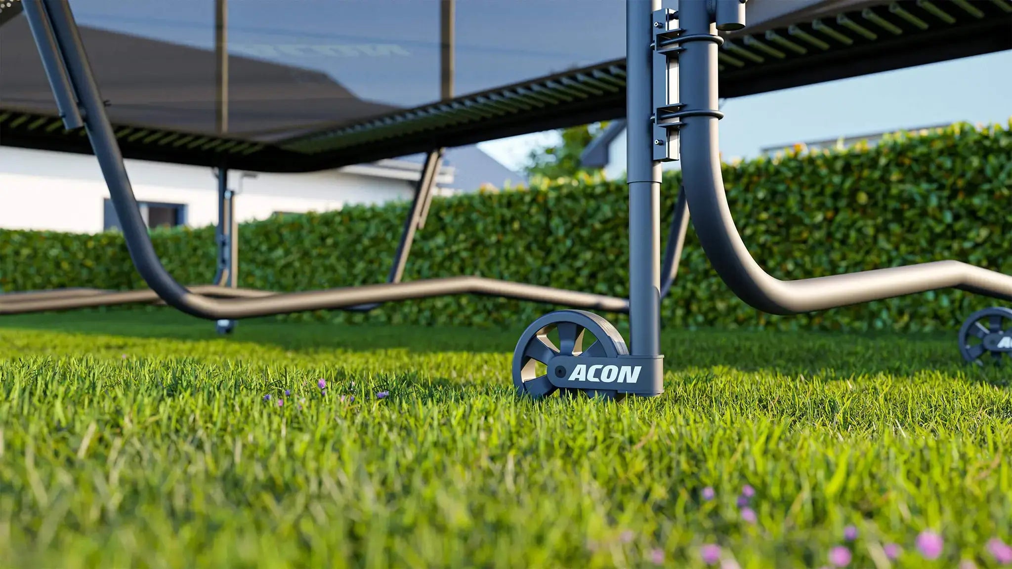 Acon Trampoline Wheel installed to a rectangular trampoline on grass.