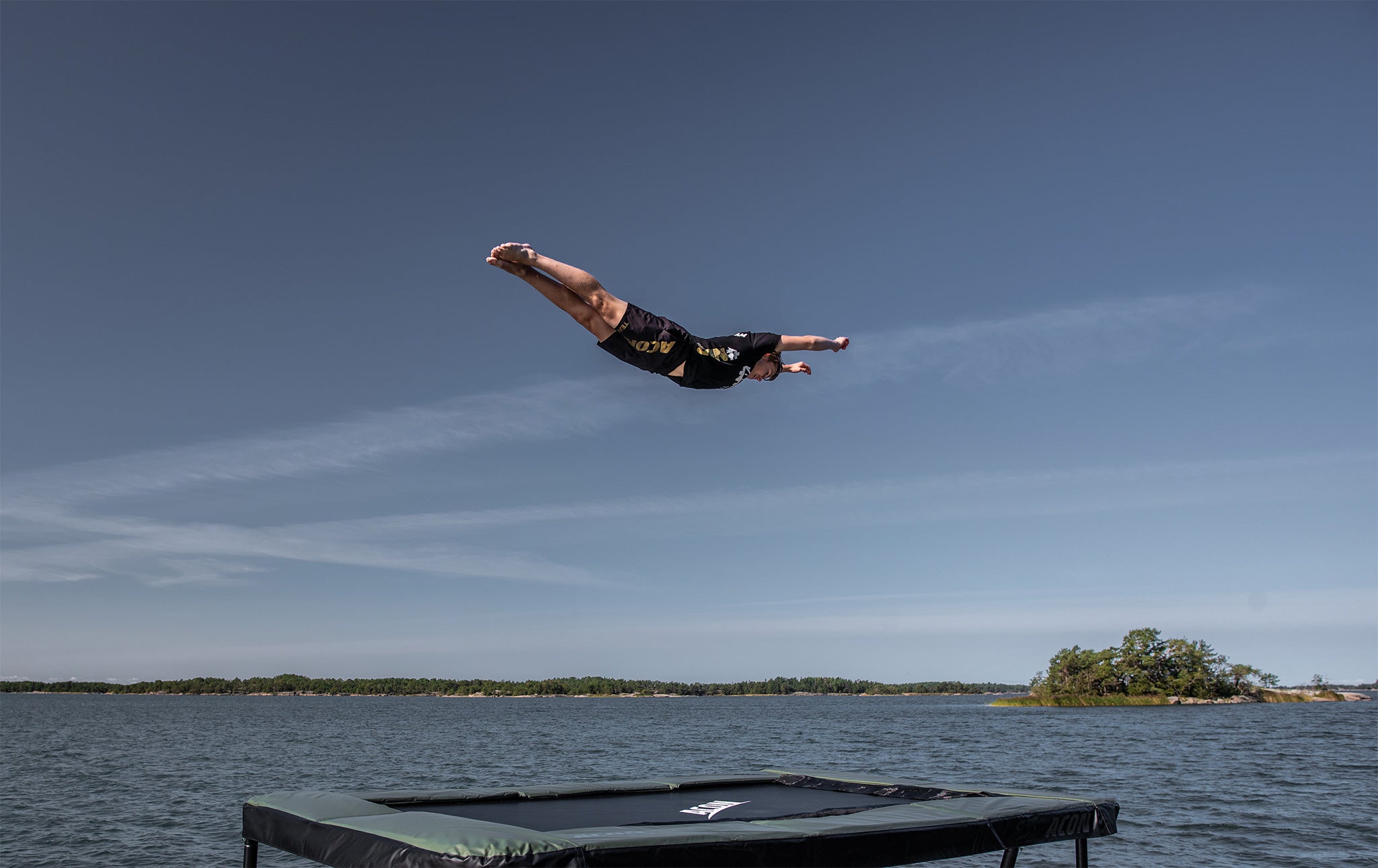 Man jumps on Acon 13 HD trampoline in an archipelago landscape