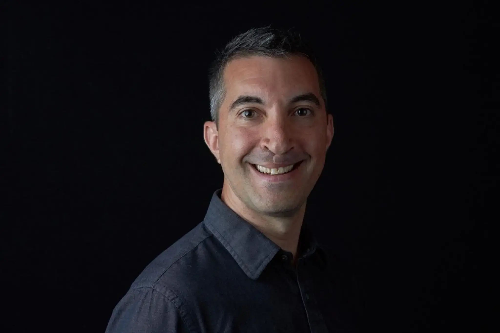 Acon's Product Specialist Dave Hepp smiling, with a black background.