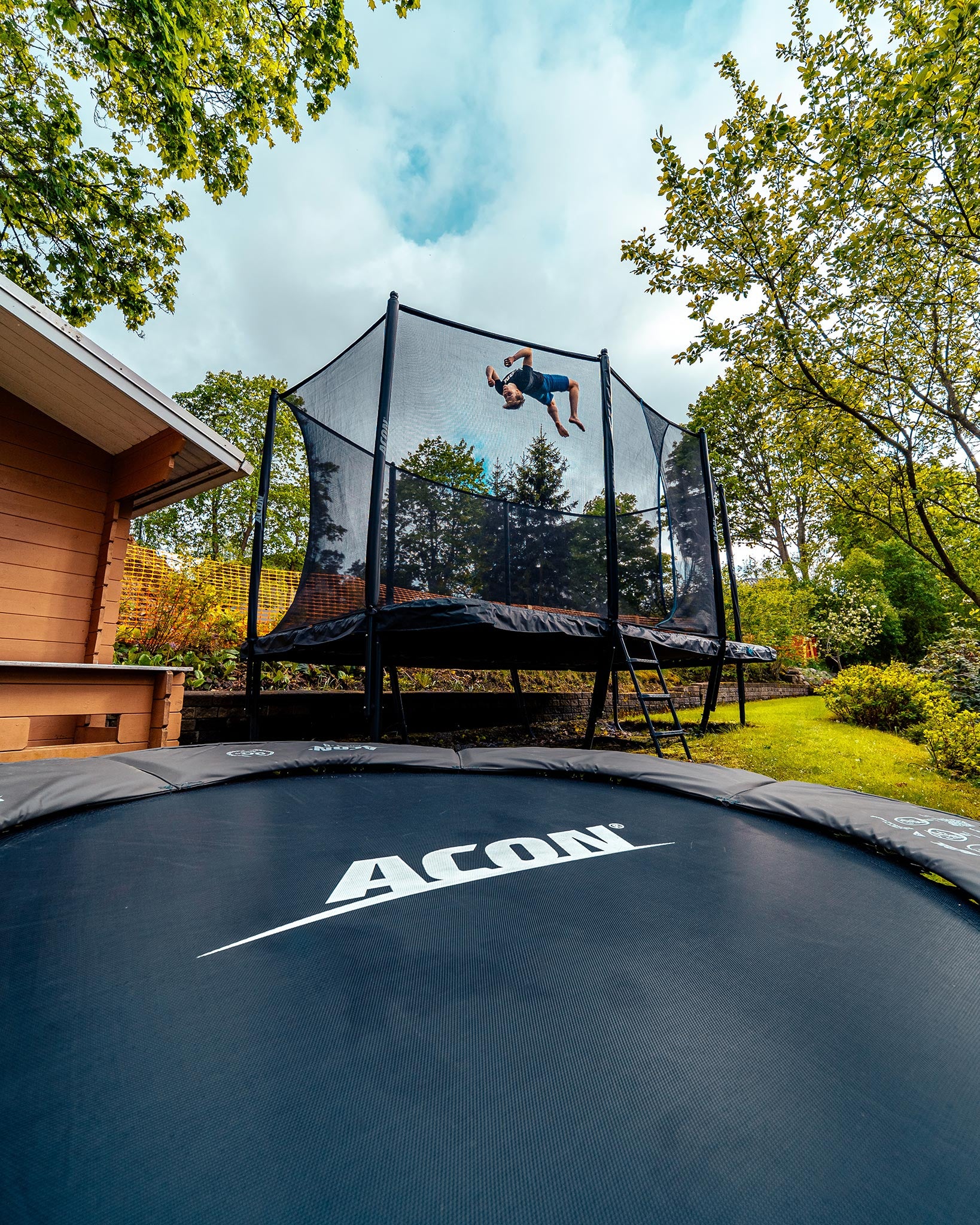 A boy jumps on a Acon 16 Sport HD trampoline with net
