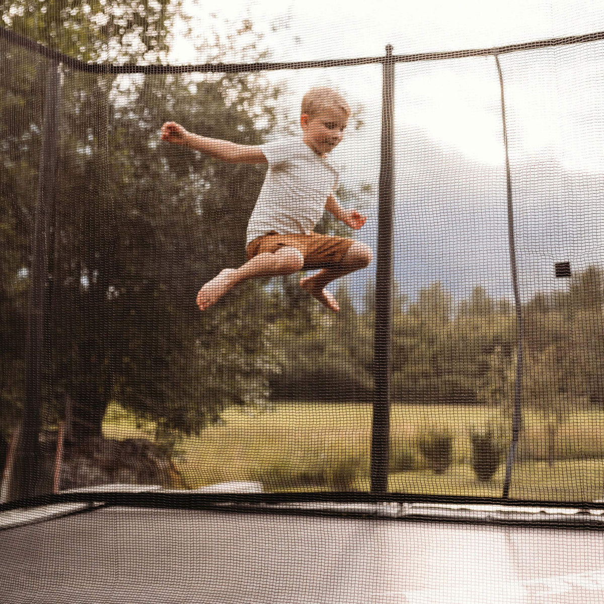A boy is jumping on the ACON 16 HD trampoline.