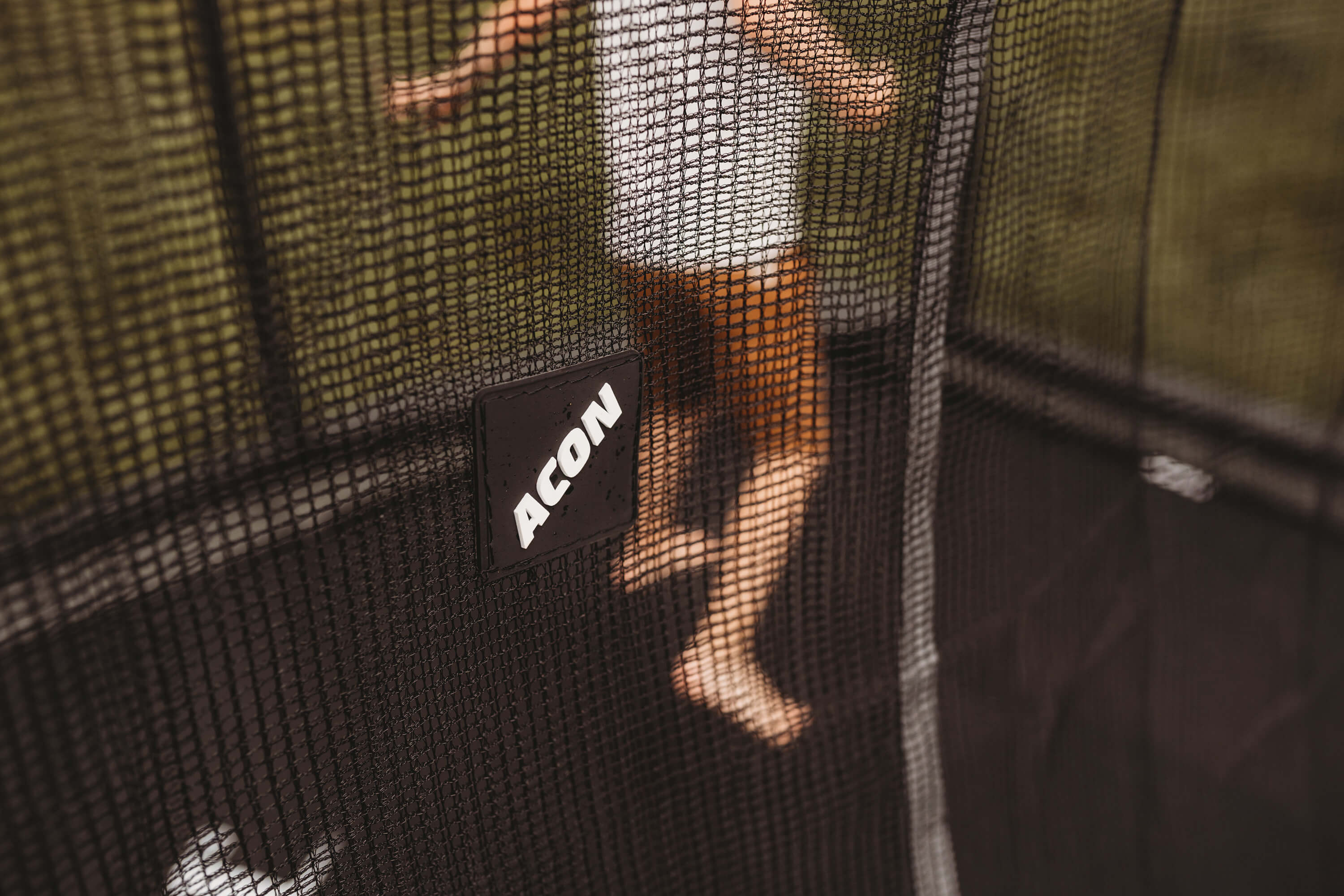 A closeup of trampoline net with ACON logo