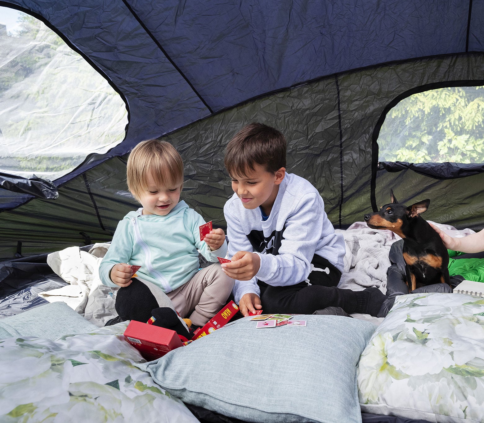 2 kids and a dog in an Acon Trampoline tent