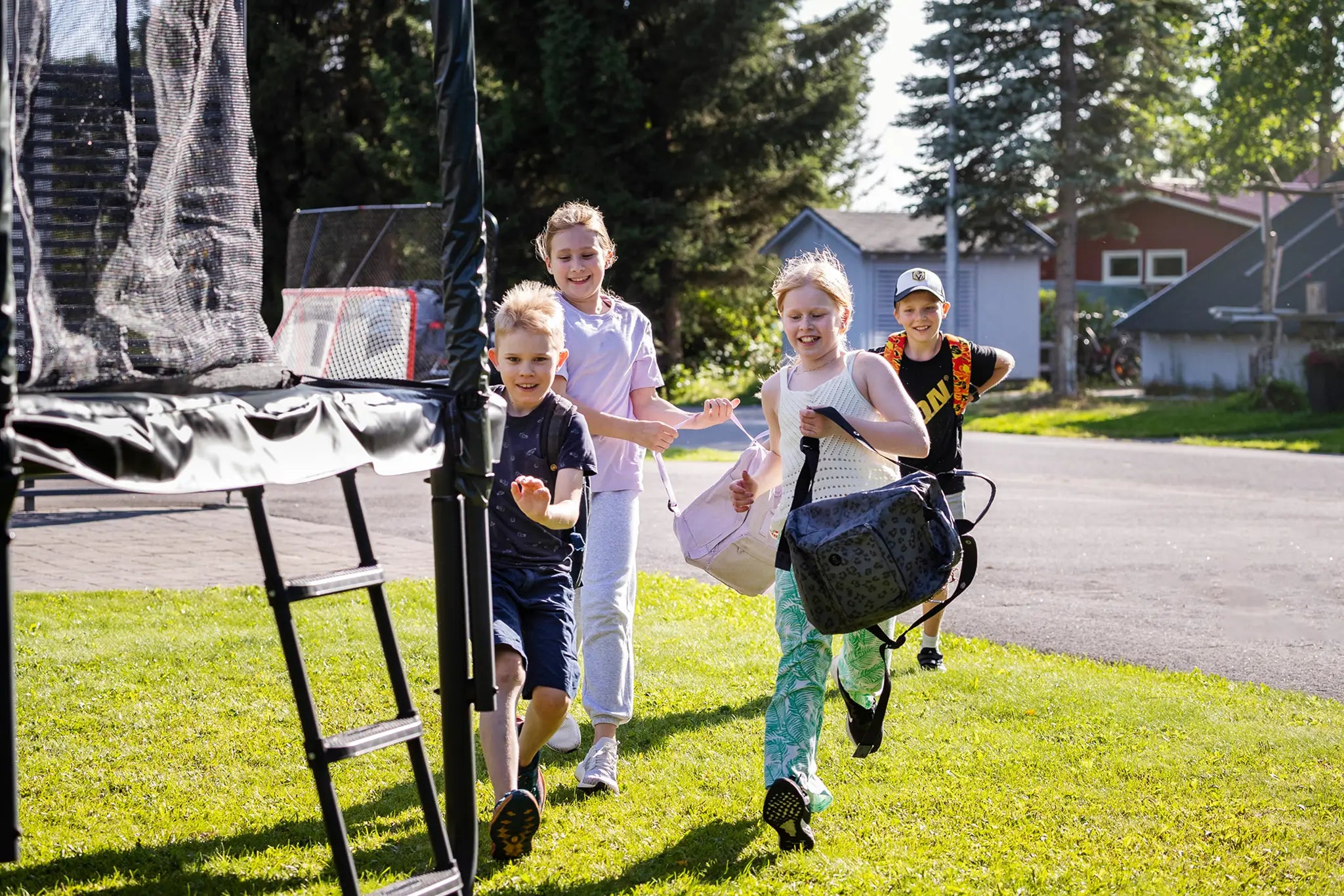 Kids running to jump on the trampoline after school.