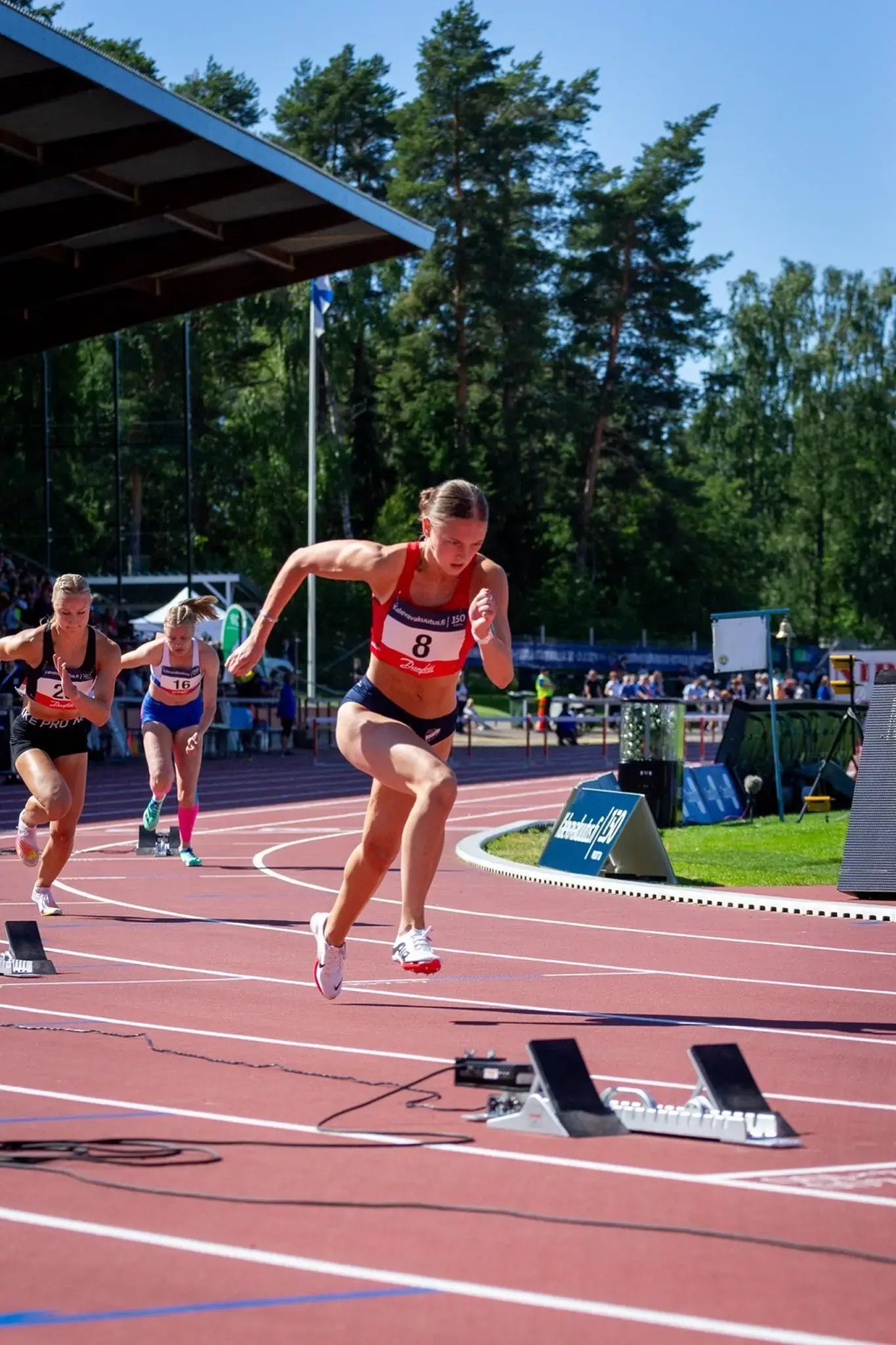 Track and field athlete Mila Heikkonen running at competition. 