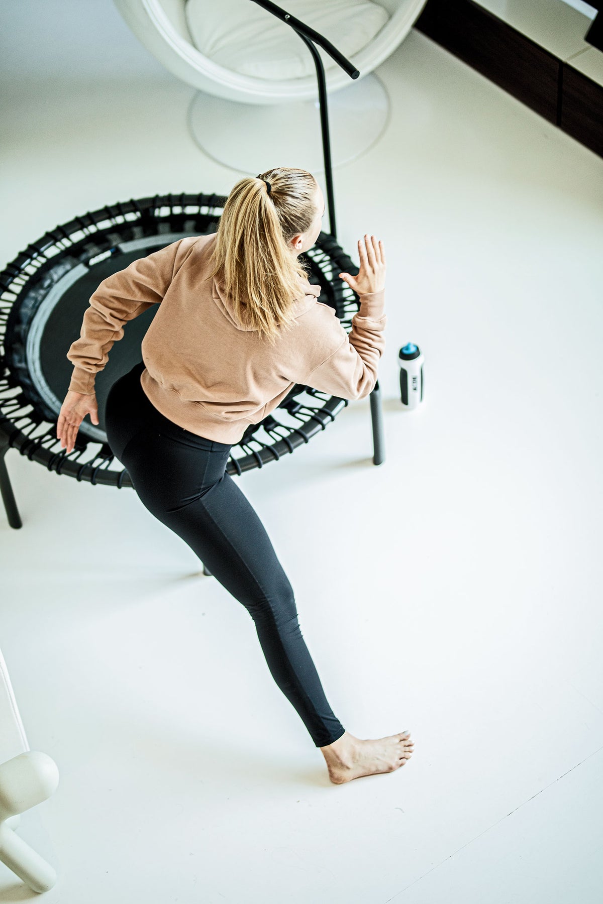 A young woman doing side steps on a rebounder