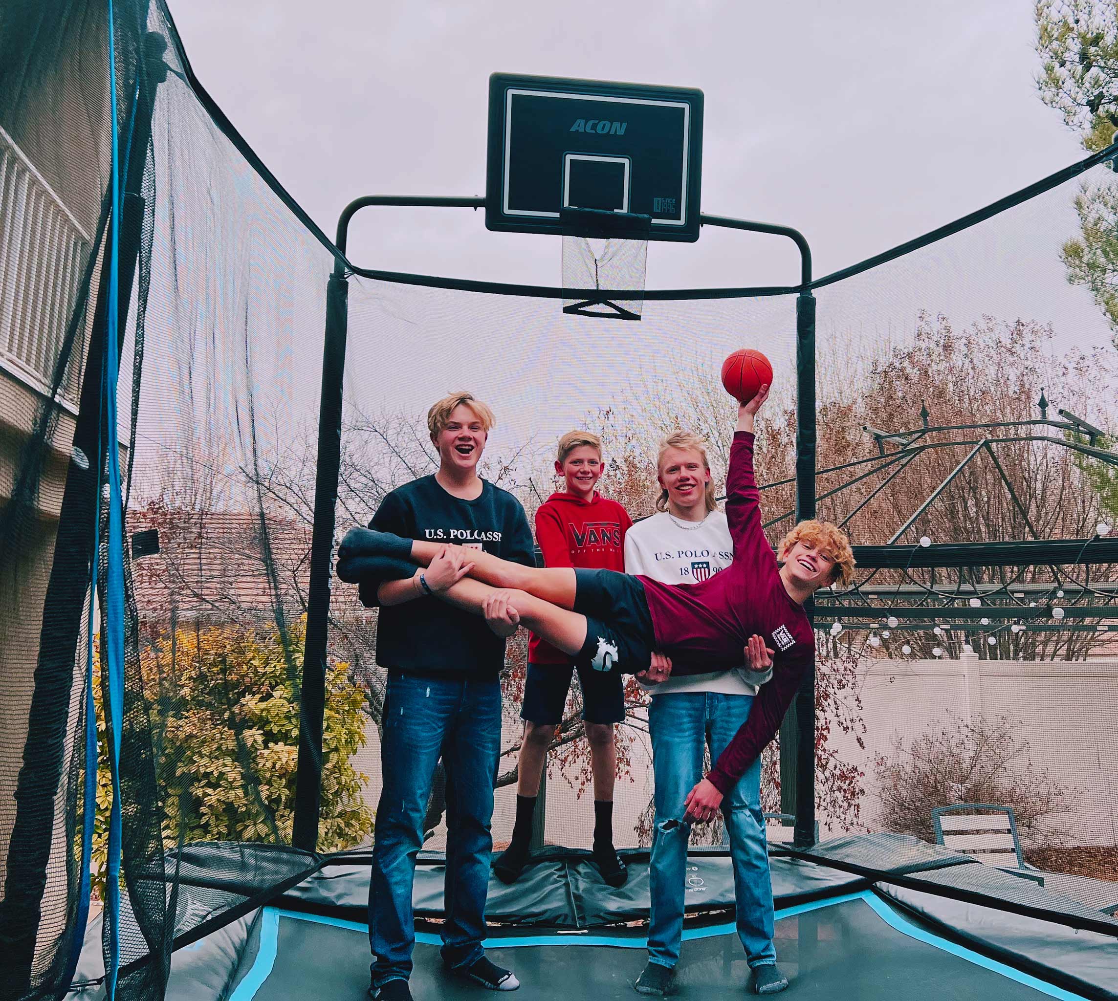 Friends standing on an Acon HD rectangular trampoline