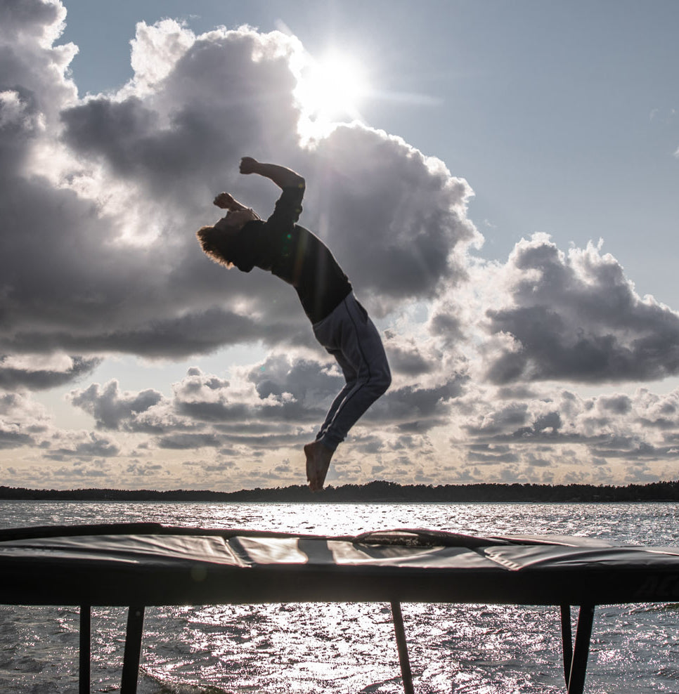 Trampoline jump with hands raised