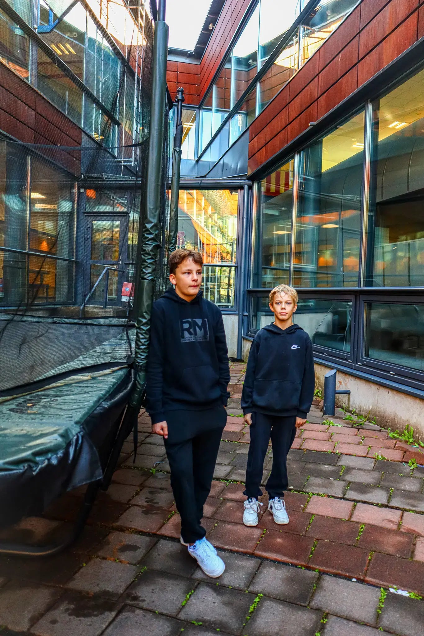 Two boys standin next to the Acon trampoline at the Kaakkuri school. 