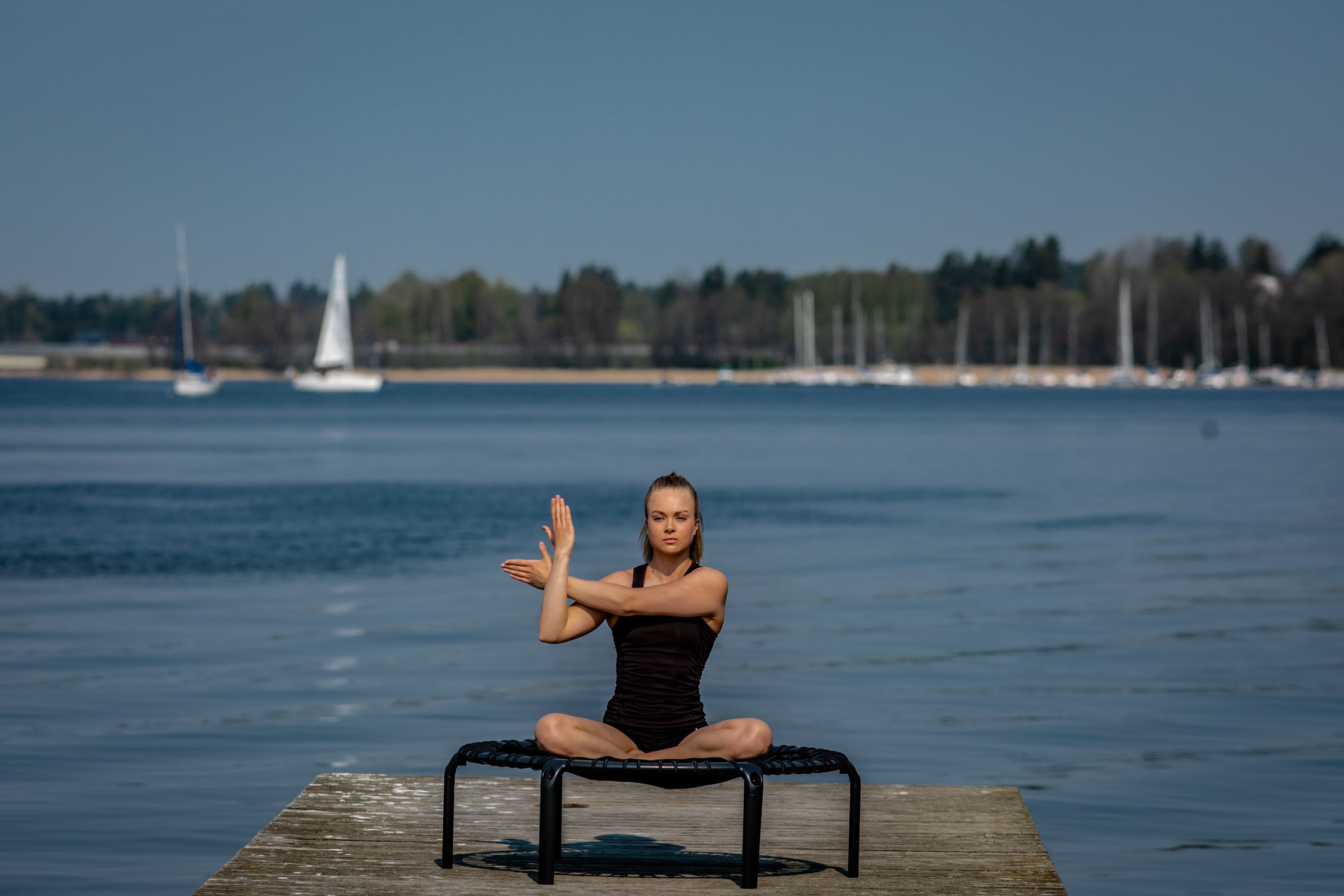 A young woman stretching and sitting on a rebounder