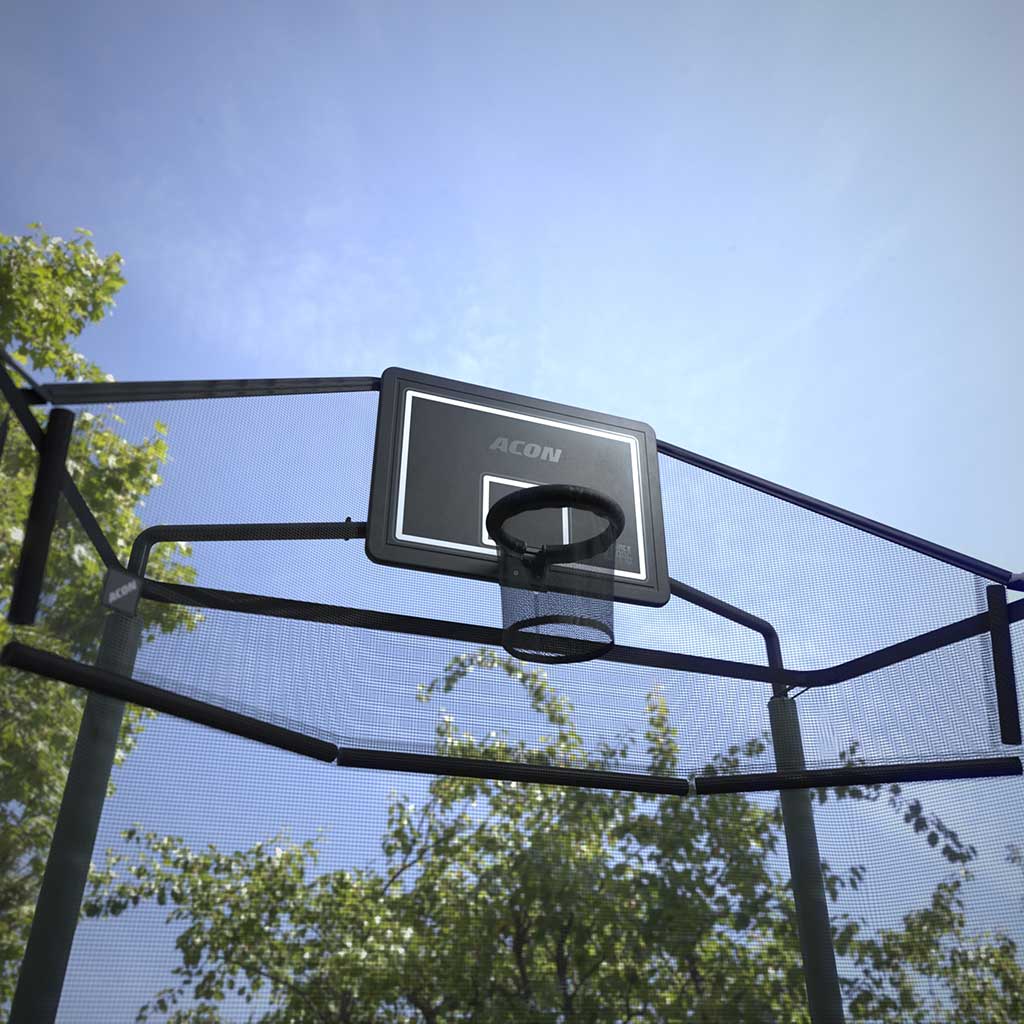 Outdoor image of the Acon Trampoline Hoop for a rectangle trampoline and its Back Net shot from below, showing blue sky and surrounding trees.