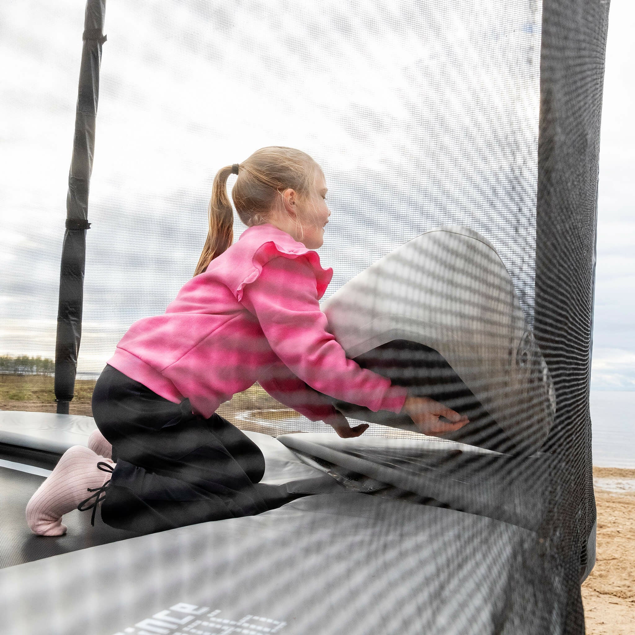 The girl sets up the Inflatable Triangle Block on the Acon X Trampoline.